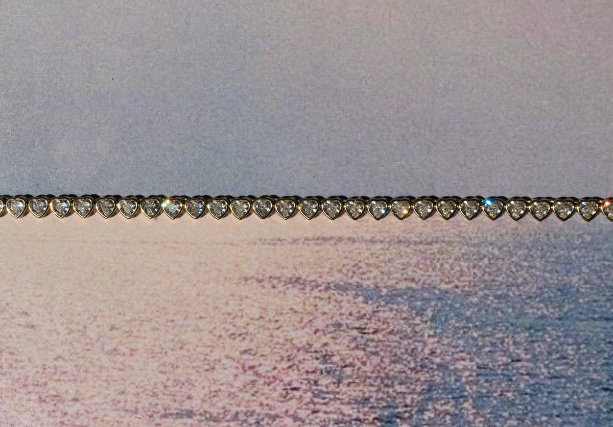 Close-up of a bracelet with heart-shaped elements on a textured background